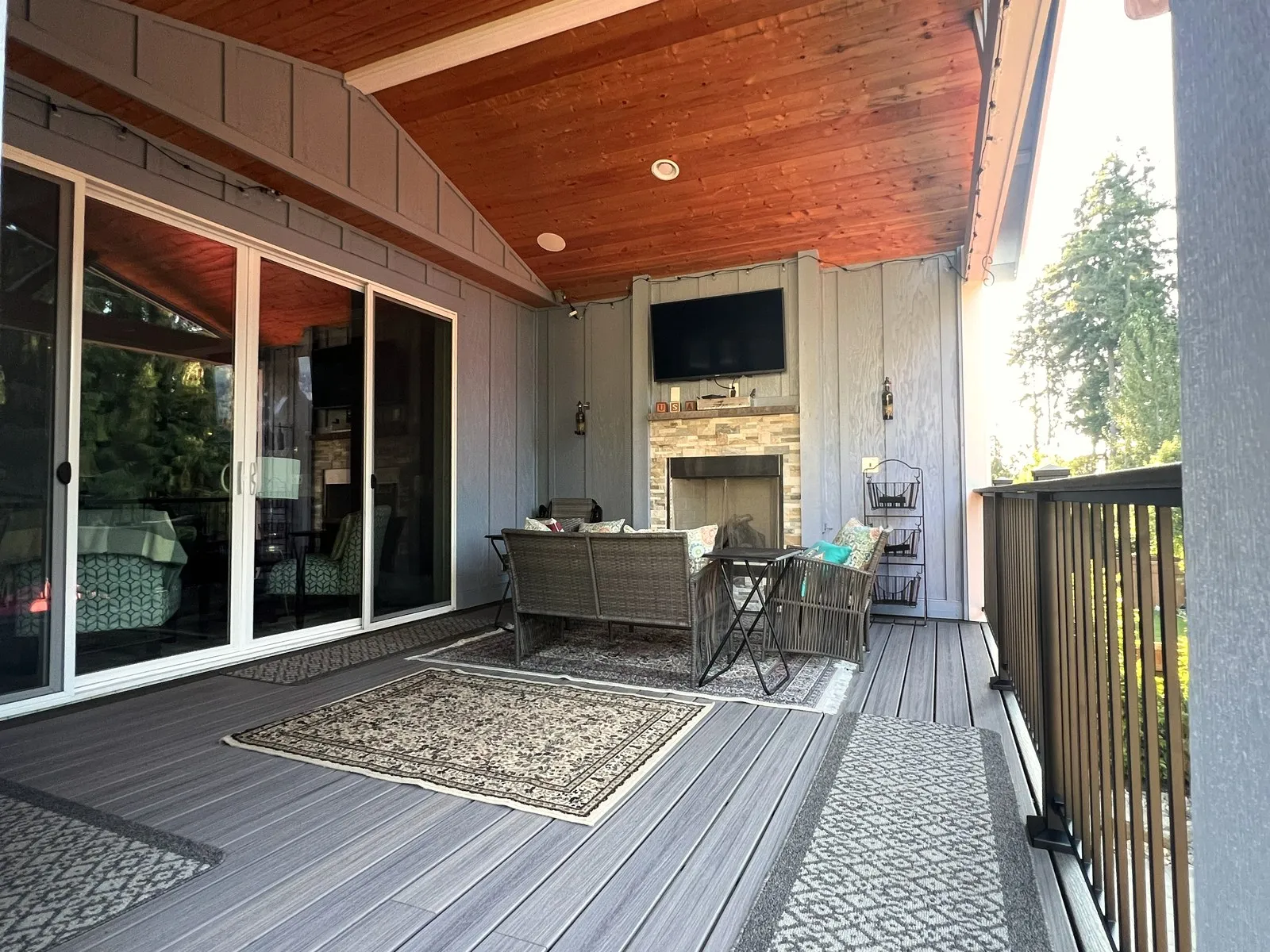A finished covered deck with composite decking and a cedar ceiling